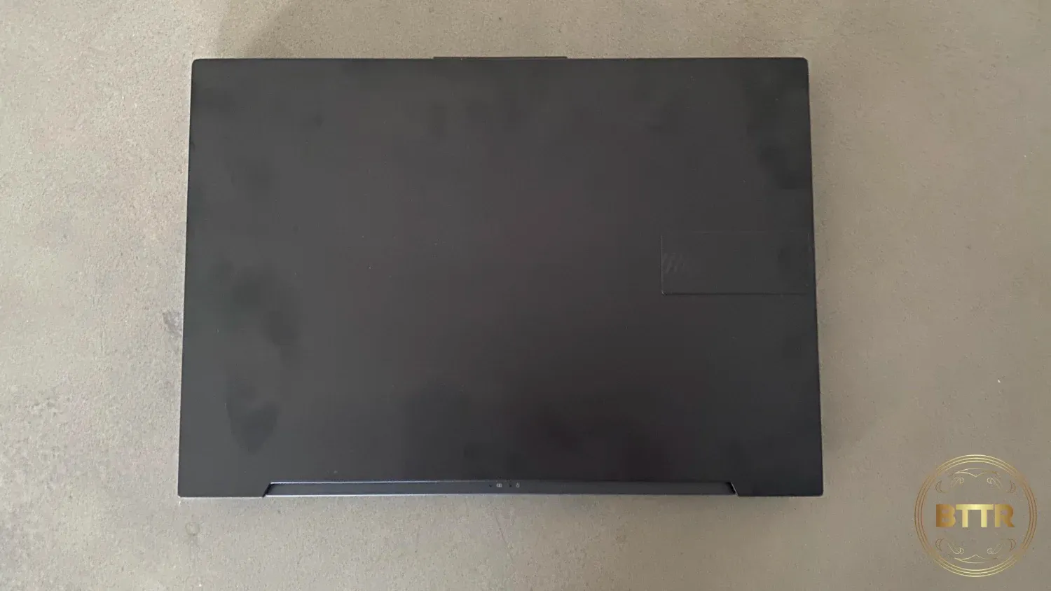The closed lid of the laptop