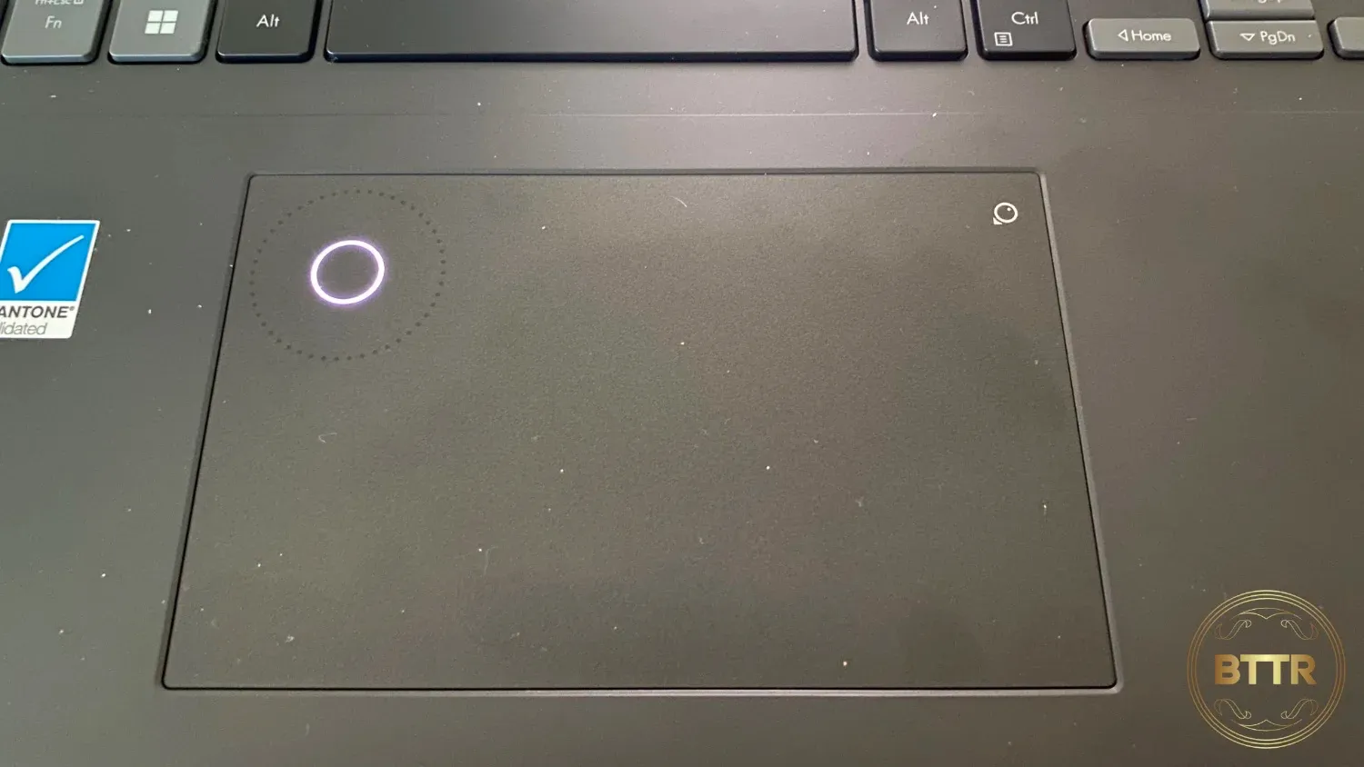 Close up of the trackpad on the ASUS Vivobook Pro 16X OLED, with the DialPad ring activated in the top left corner