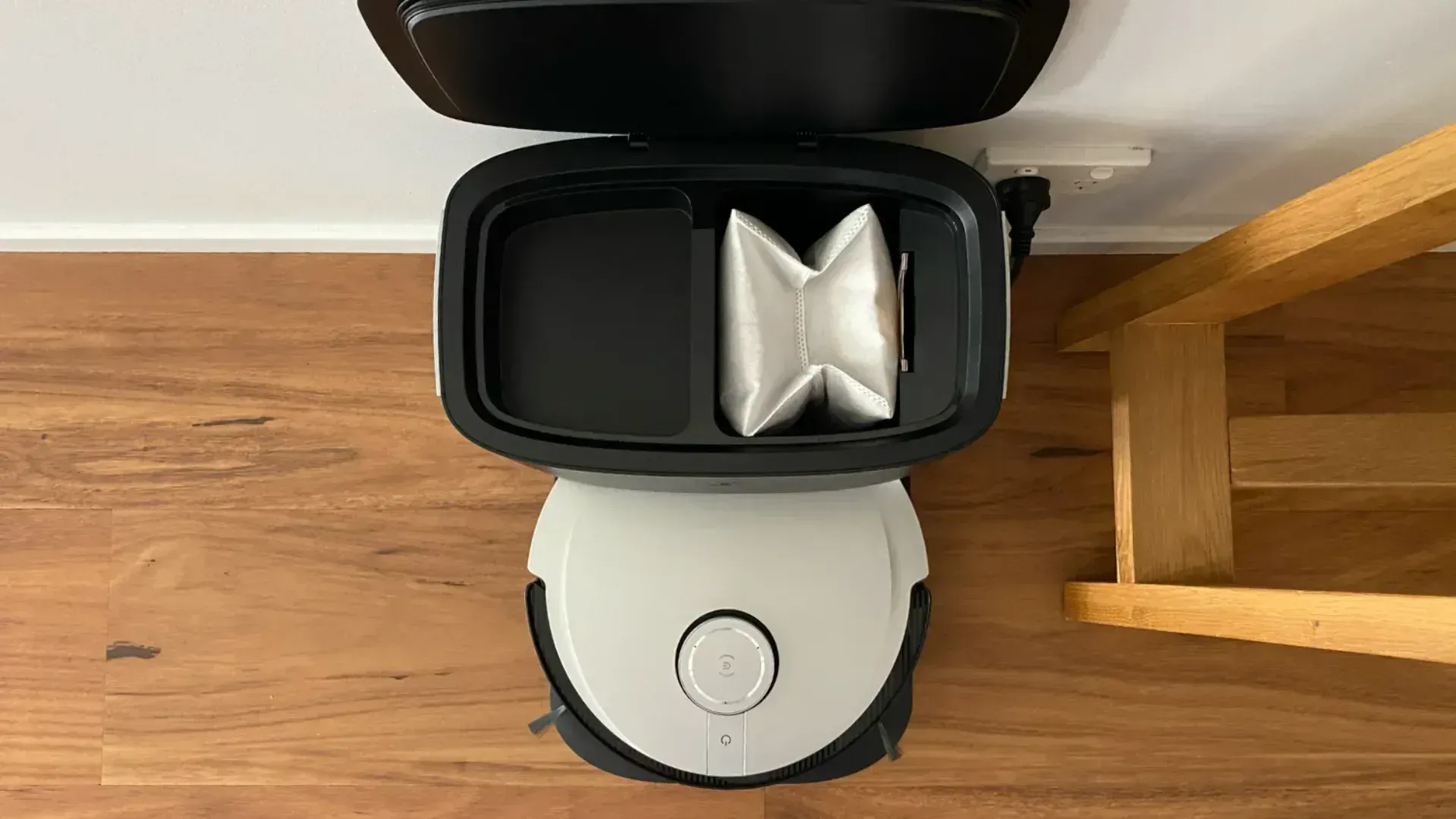 Looking inside the base station at the dust bag of the Deebot X1 Plus