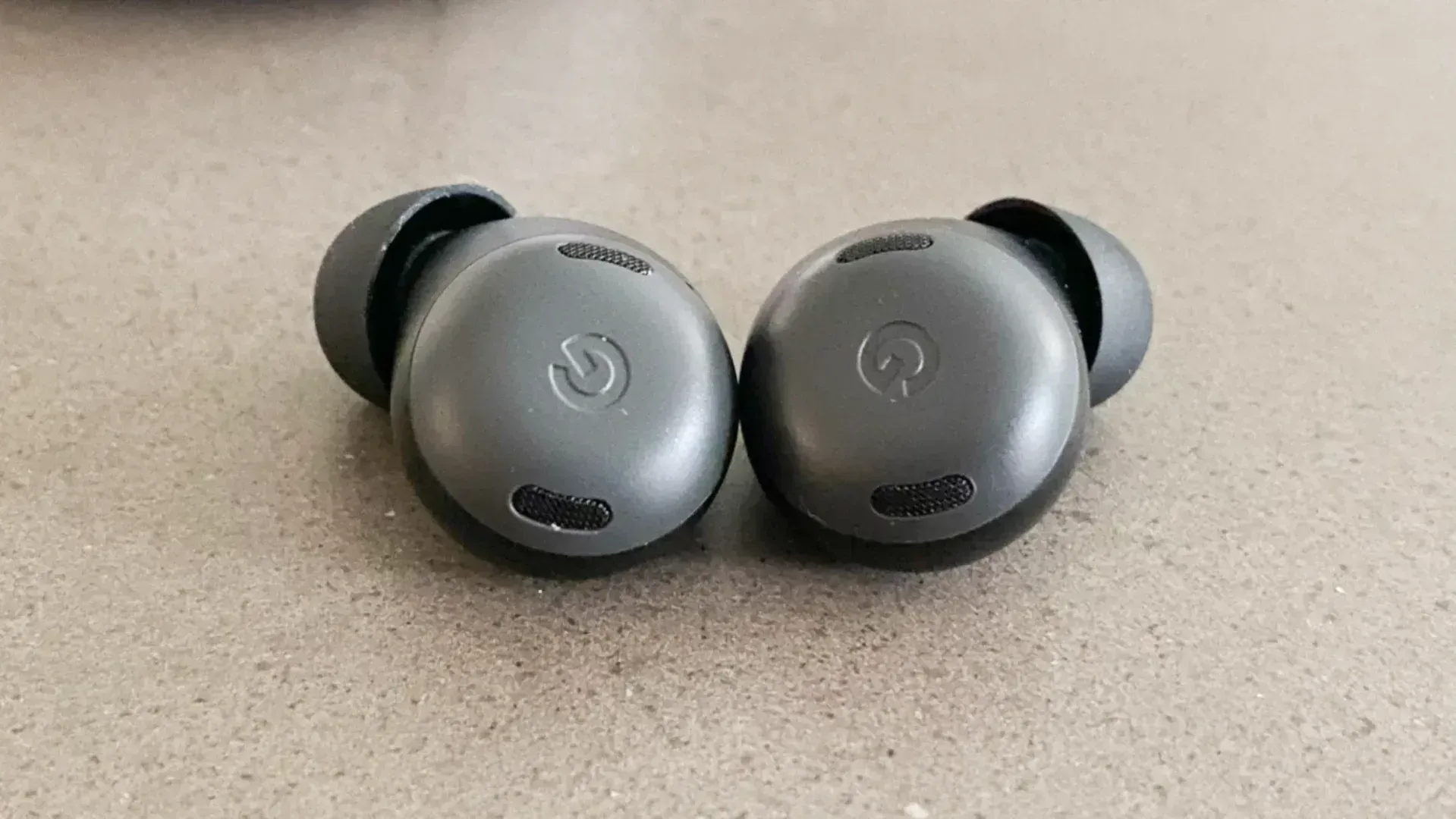 Google Pixel Buds Pro review earbuds on concrete
