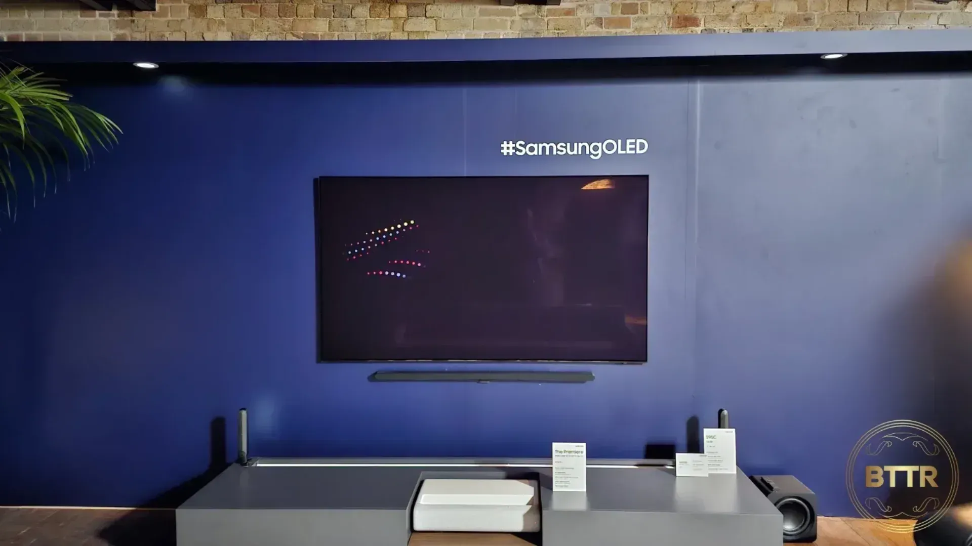 A Samsung OLED TV mounted on the wall