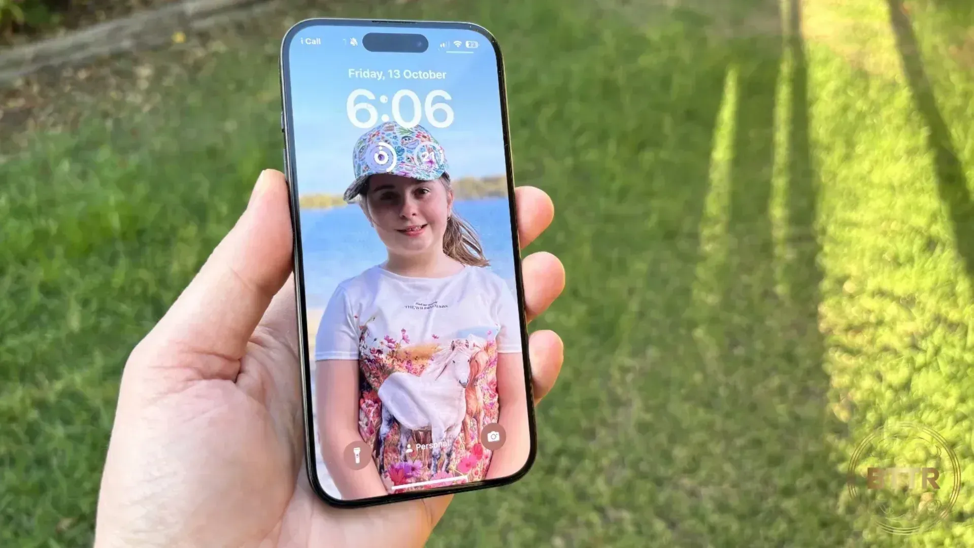 iPhone 15 Pro in the hand outside in full sun