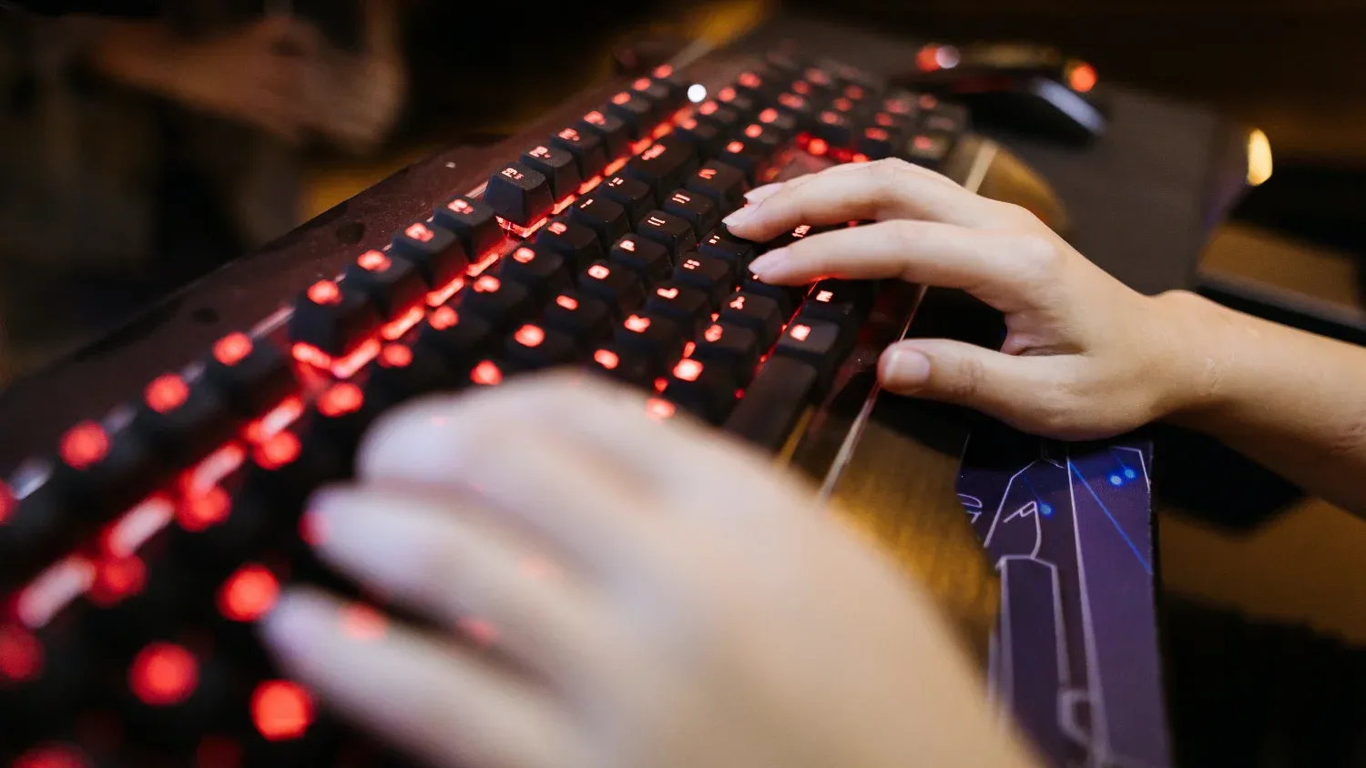 Hands typing on a gaming keyboard
