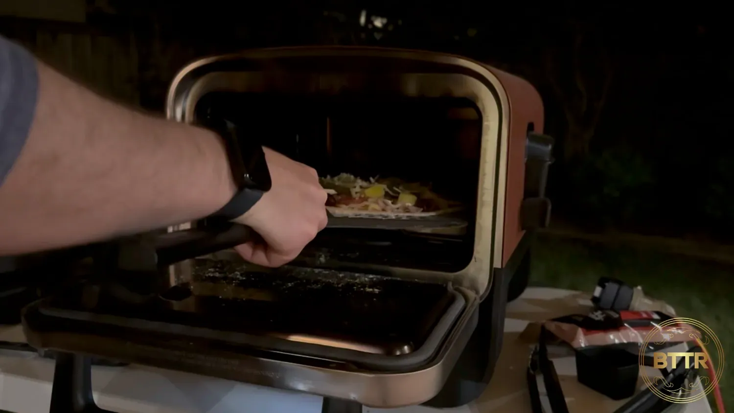 Me struggling with the pizza peel in the Outdoor Oven