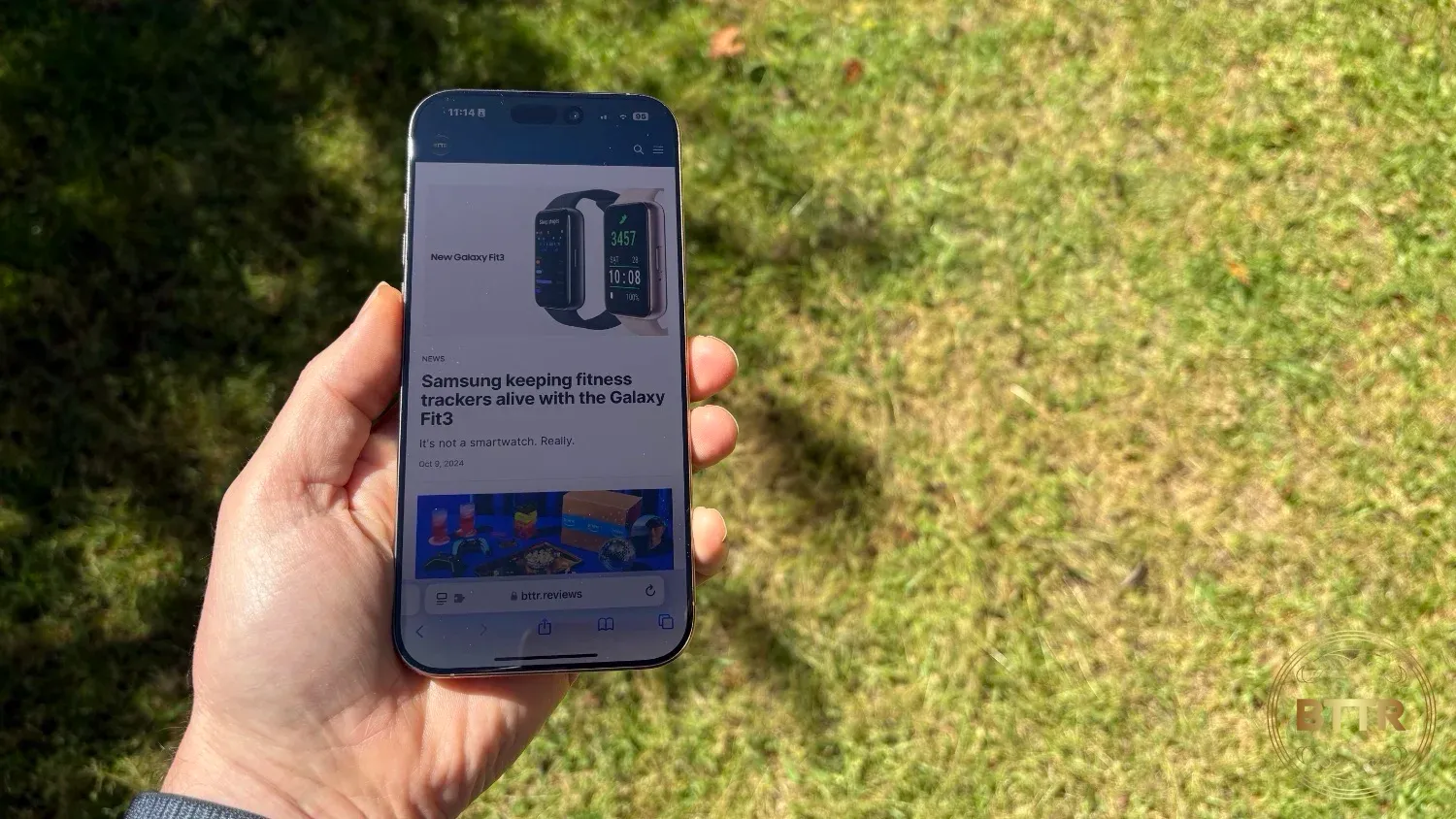 Holding the iPhone 16 Pro Max outdoors
