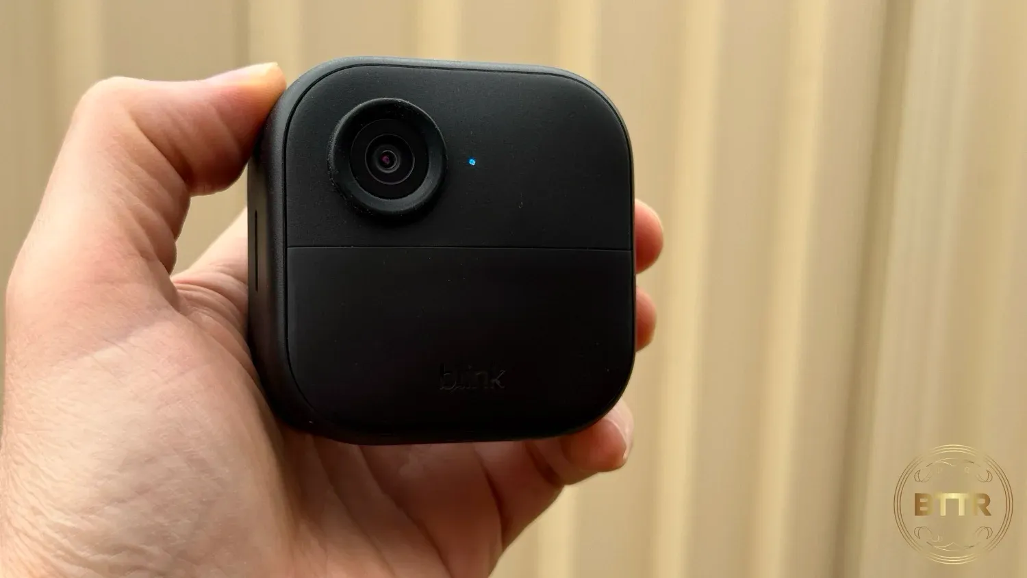 Holding the Blink Outdoor 4 camera in hand