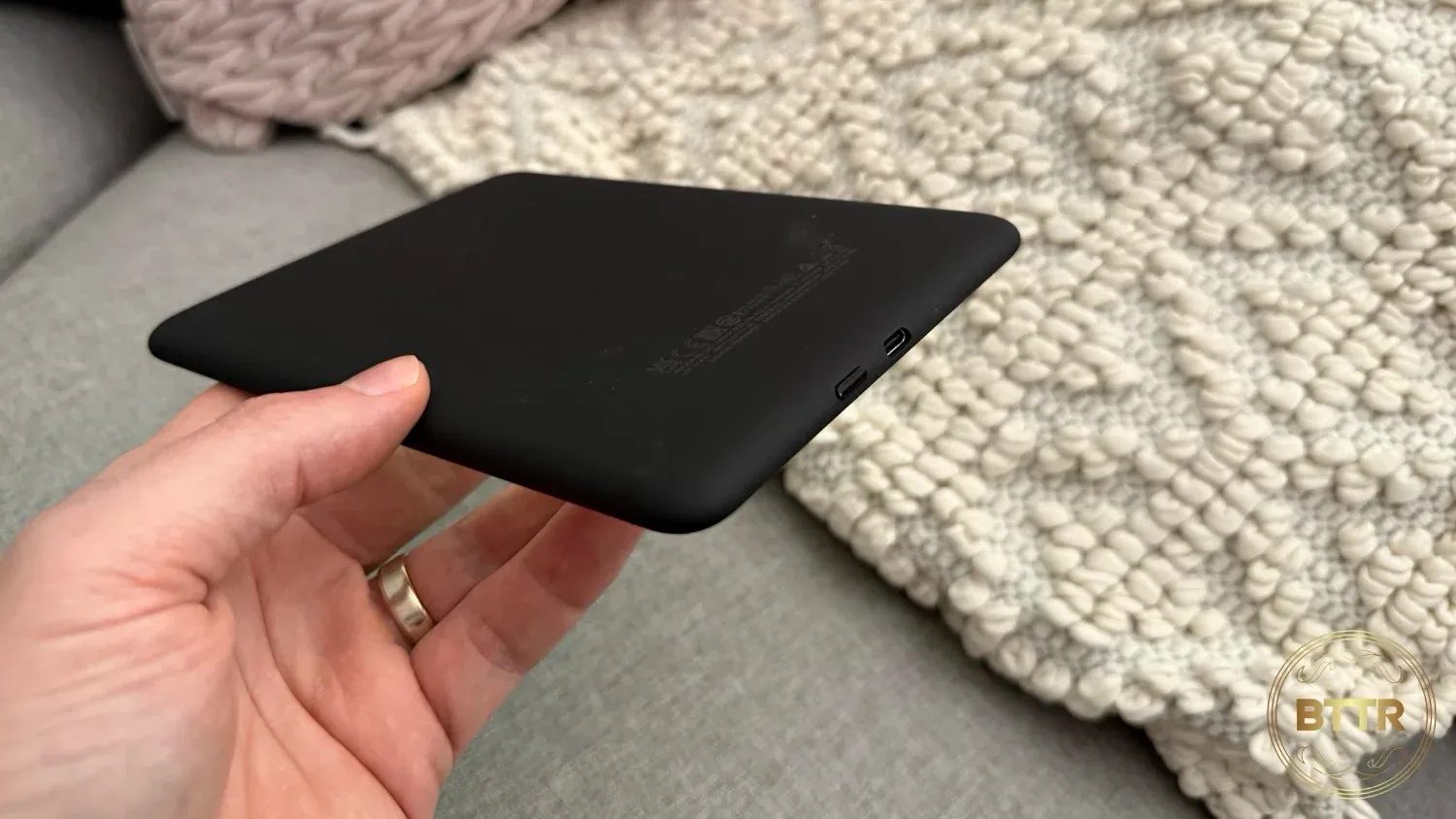 The power button and charging port on the bottom of the Paperwhite