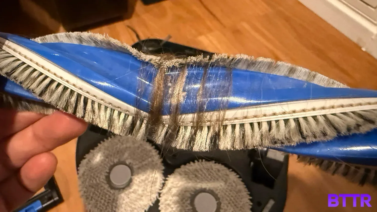 The main brush of the X5 Pro Omni, tangled with hair despite its anti-tangle technology