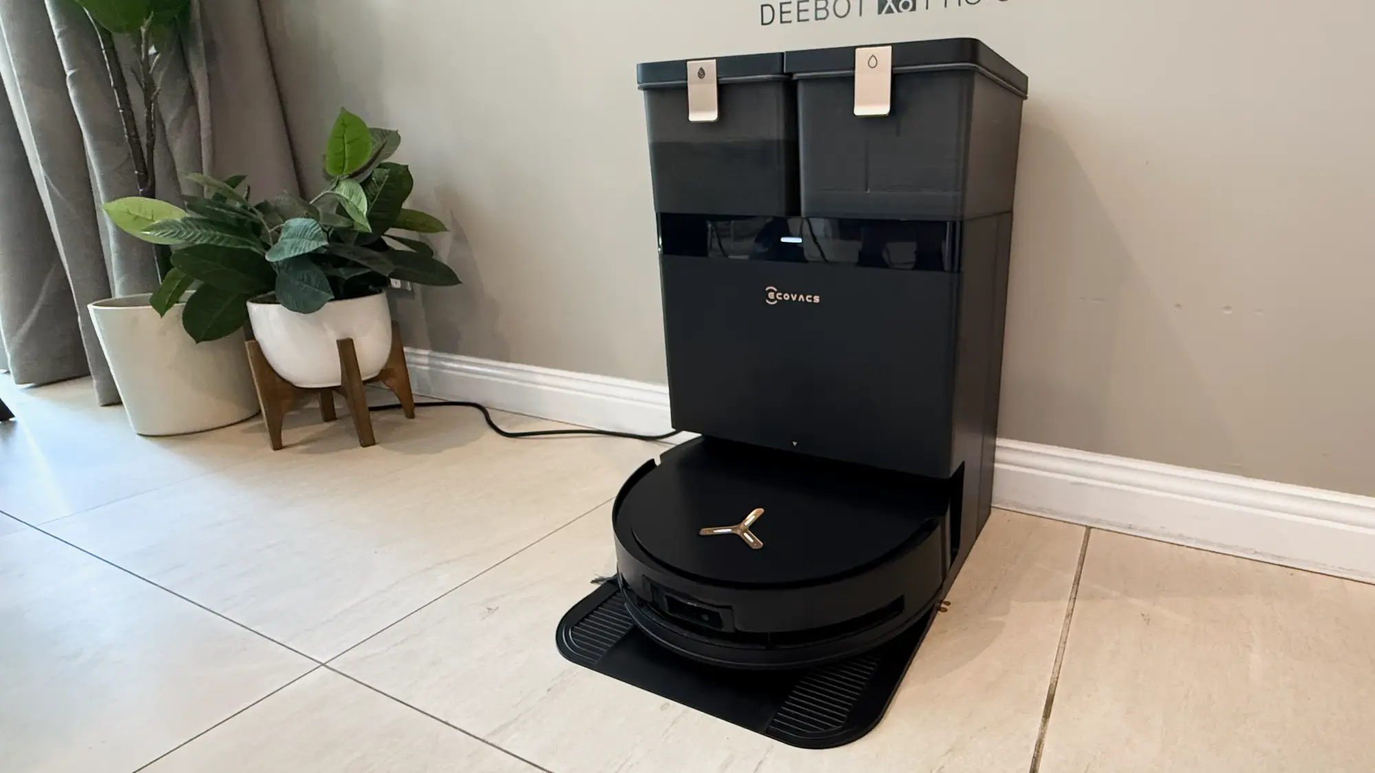 The Deebot X8 Pro Omni in its base station on a tiled floor.