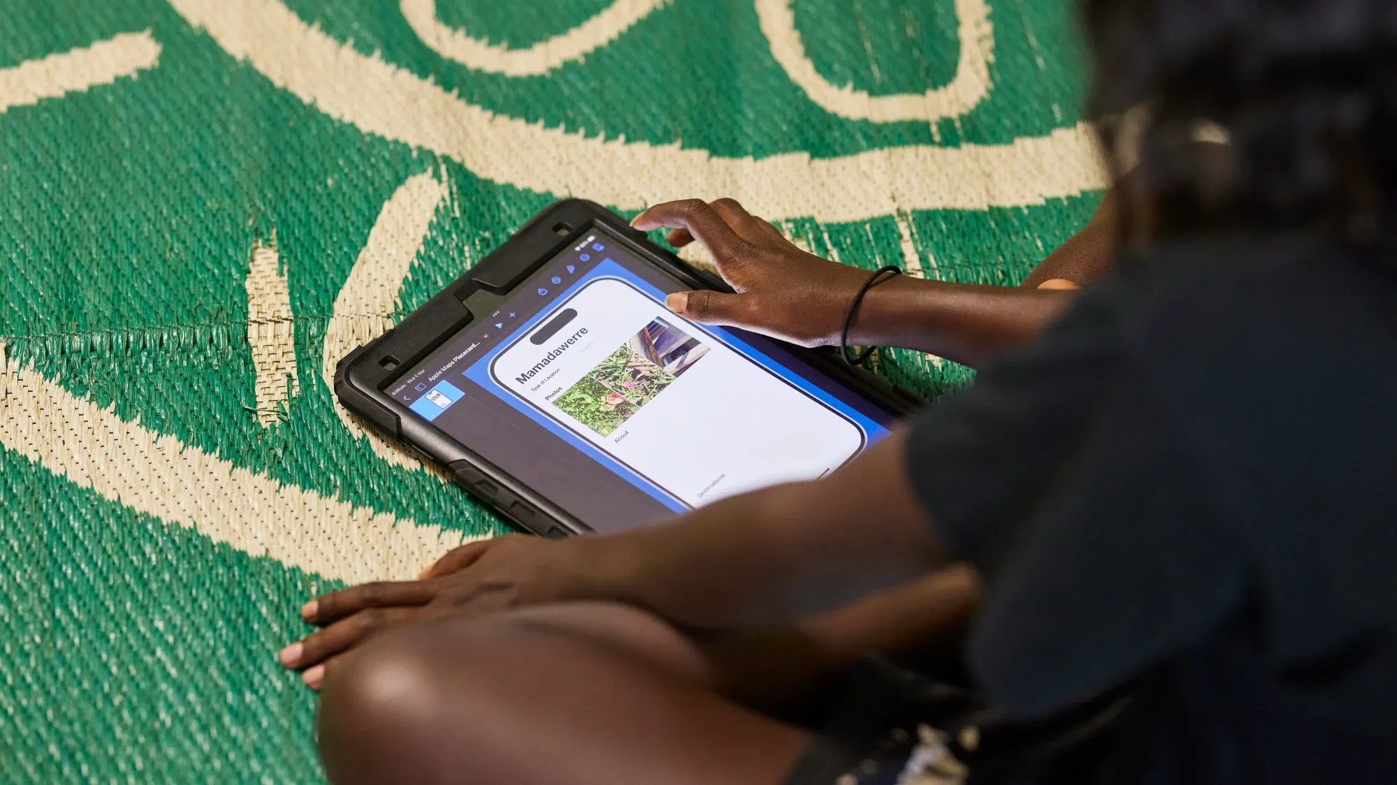 A young Aboriginal child working on an iPad for the community mappping initiative