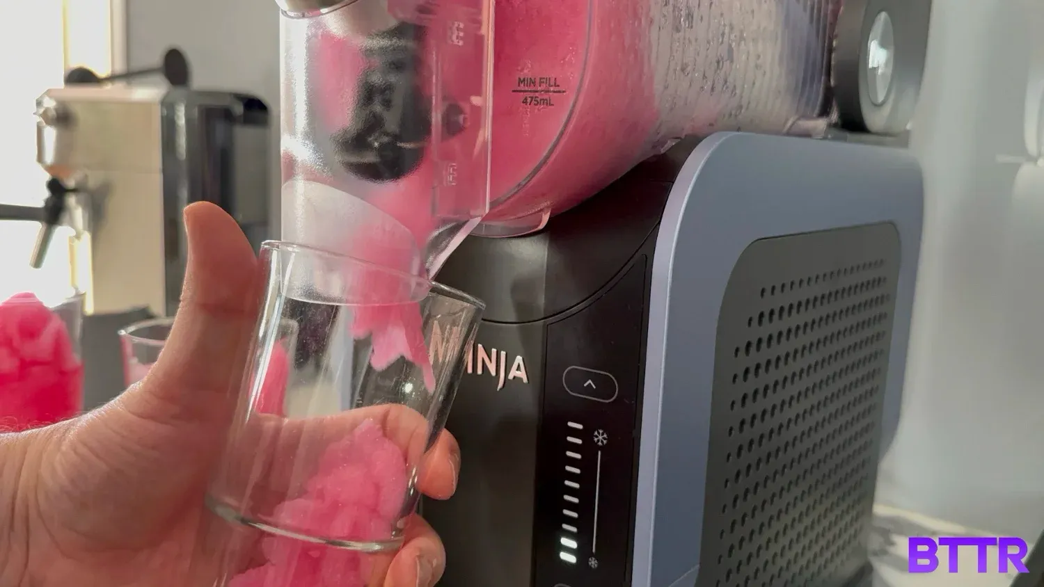 Pouring out the pink slushie from the Ninja Slushi