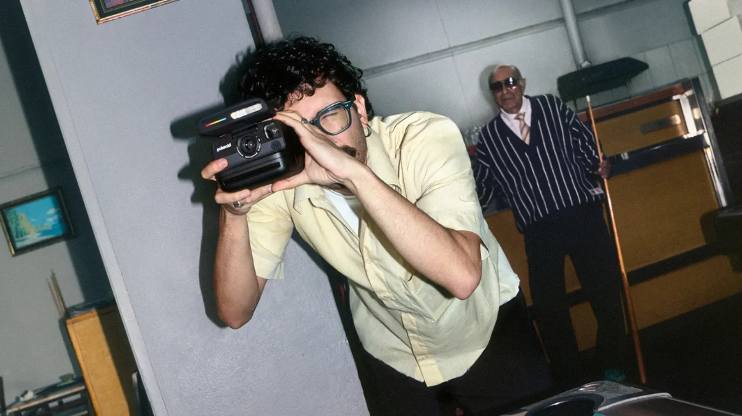 A man taking a photo with the Polaroid Flip camera