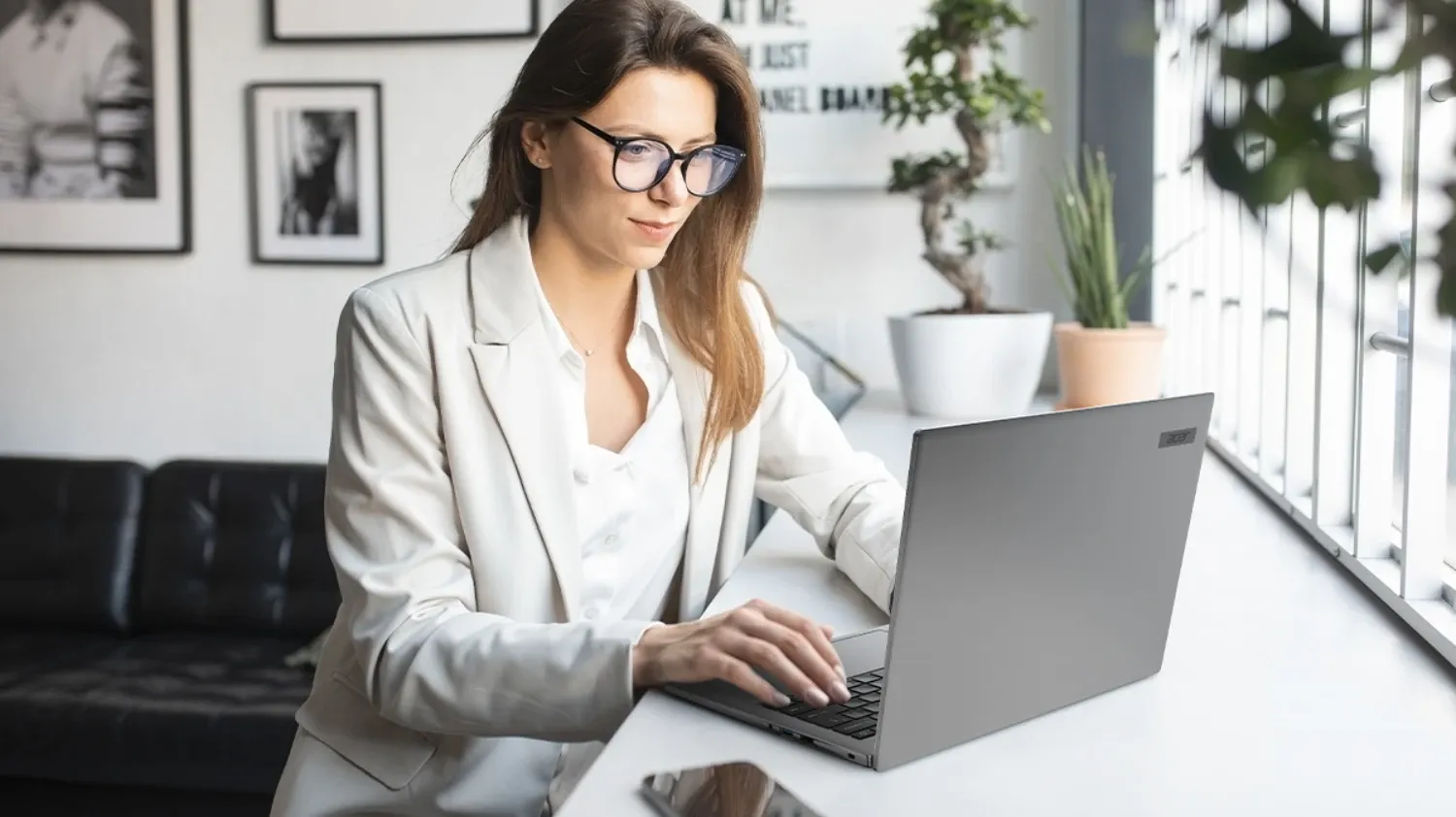 A woman working on the new Travelmate laptop