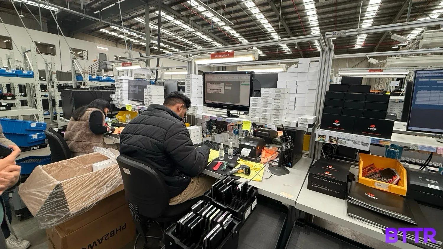 A man comprehensively cleaning a phone for resale.