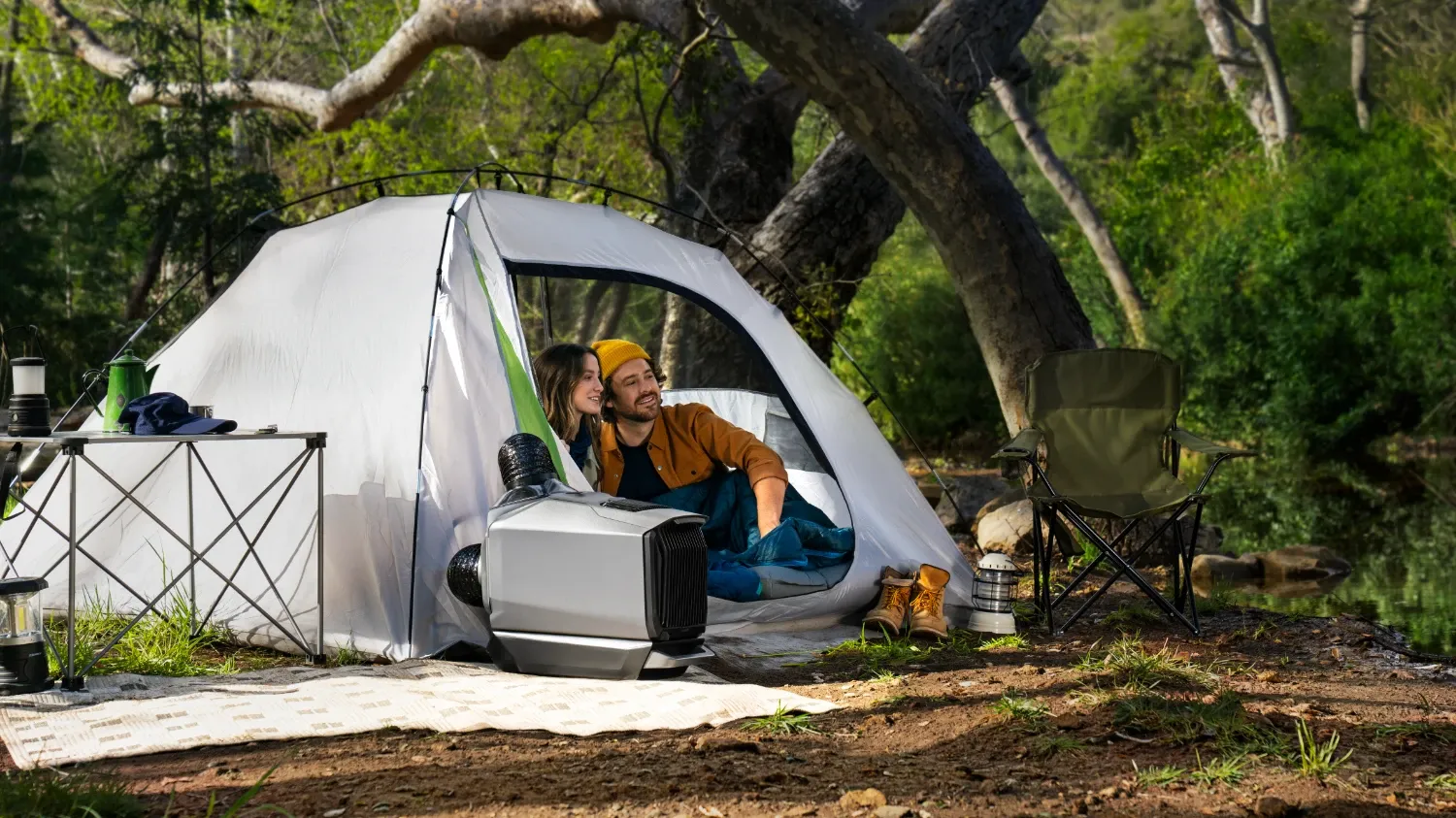 A couple in a tent with the flap open and the Wave 3 blowing in air. It doesn't really make sense –they should have the flap closed if the air con is on!