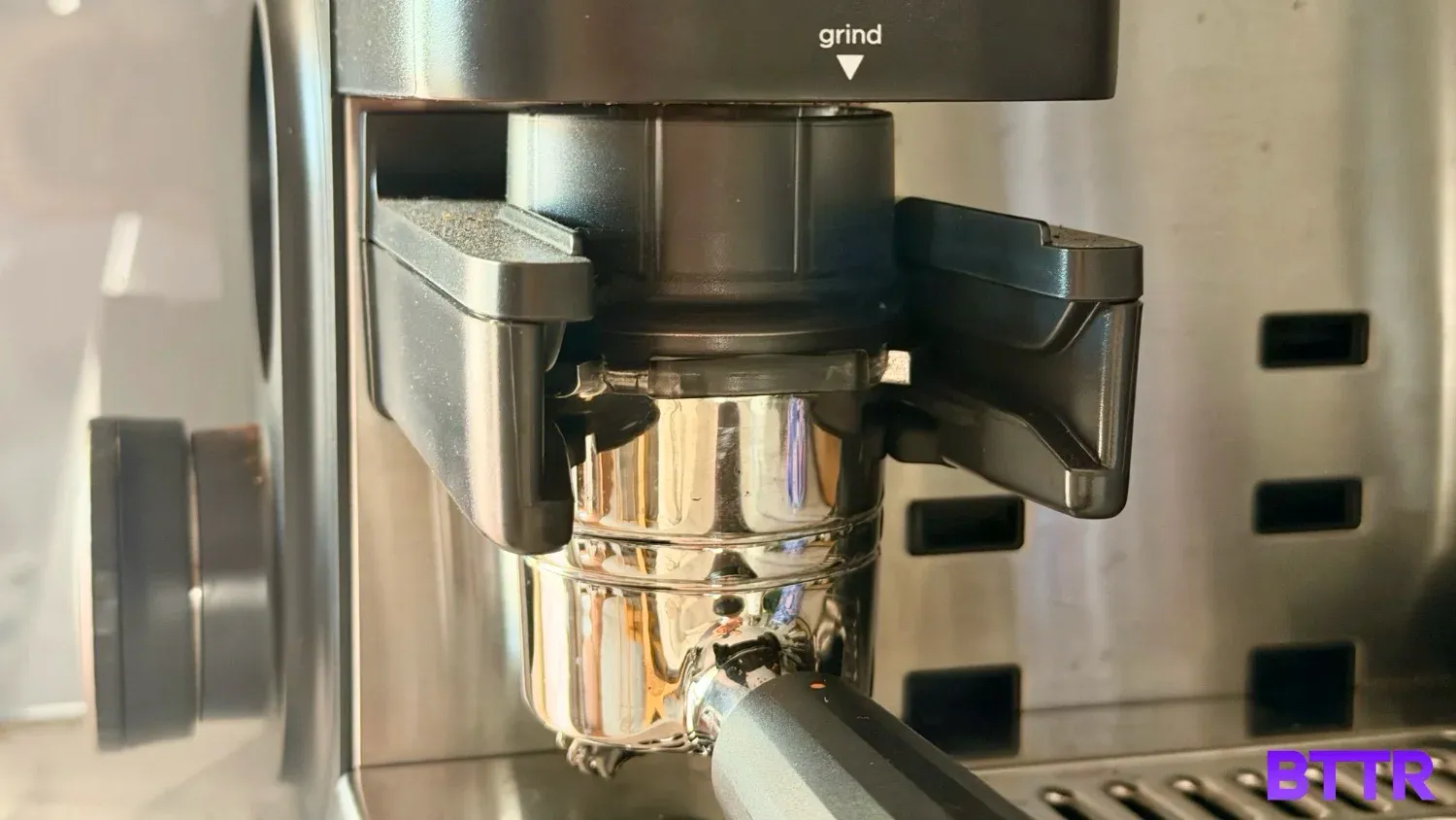 The Ninja Luxe Café Premier portafilter with the funnel attached, collecting coffee beans