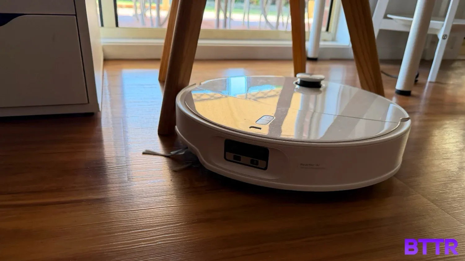 The Roborock Qrevo Edge 2 Pro cleaning around furniture