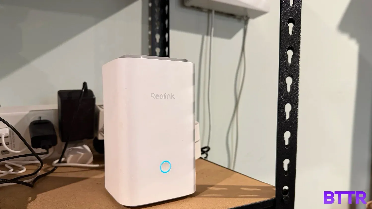 The ReoLink Homehub on a shelf in a garage with a power board in the background.