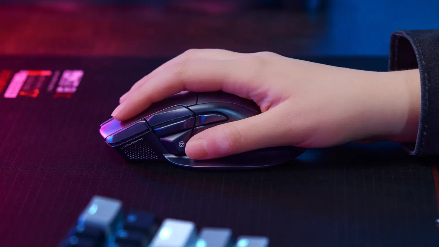 A hand using the Nightsword v2 Wireless SD mouse