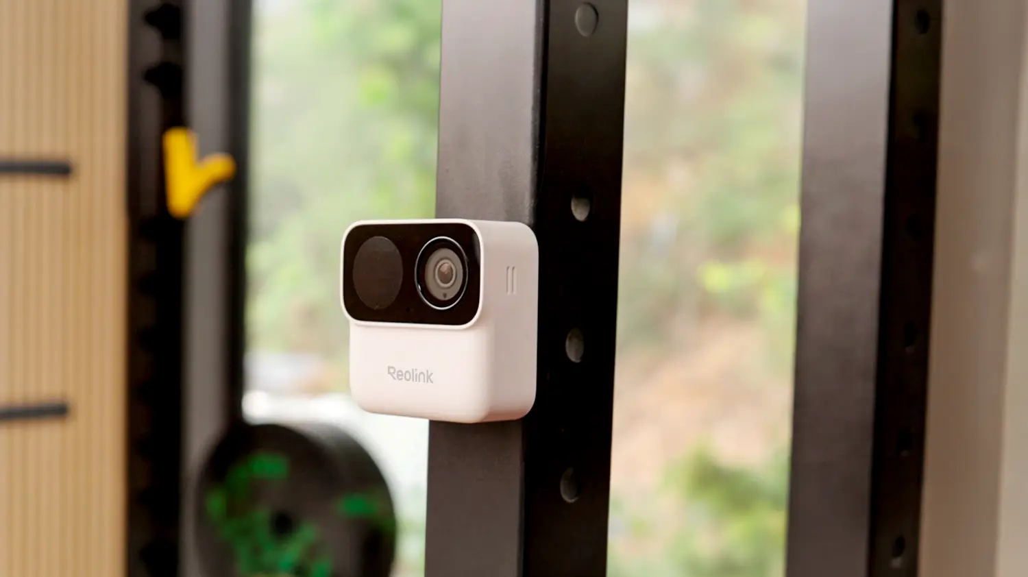 The Reolink Argus Magicam attached to a post an front of a window