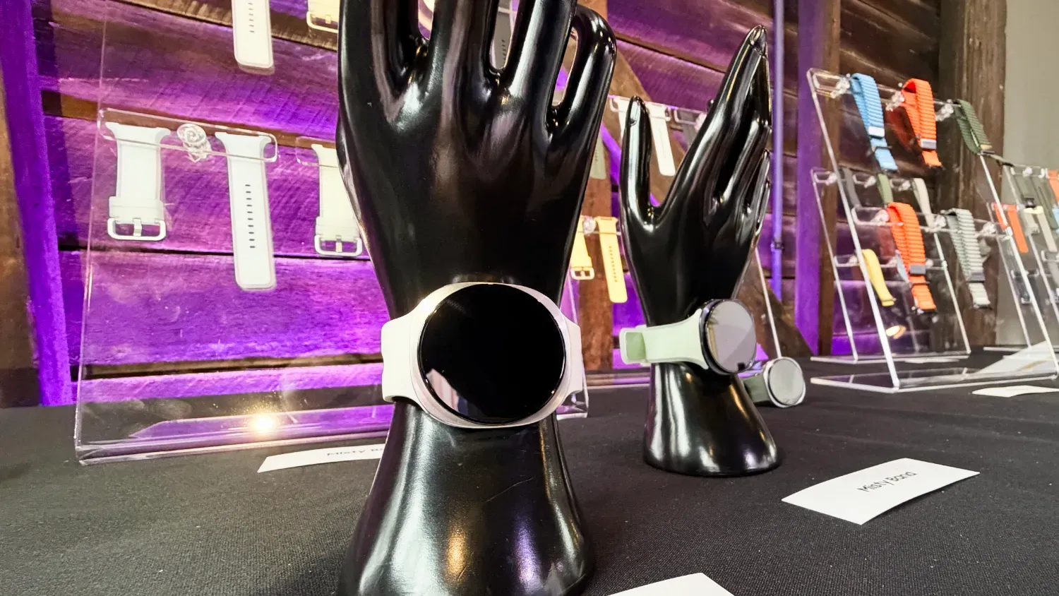 The Galaxy Watch9 on a mannequin hand in front of a range of band accessories