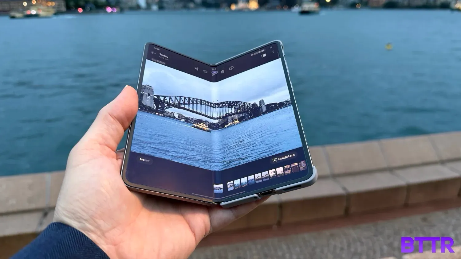 The OPPO Find N6 half folded with a photo of the harbour bridge on its larger display