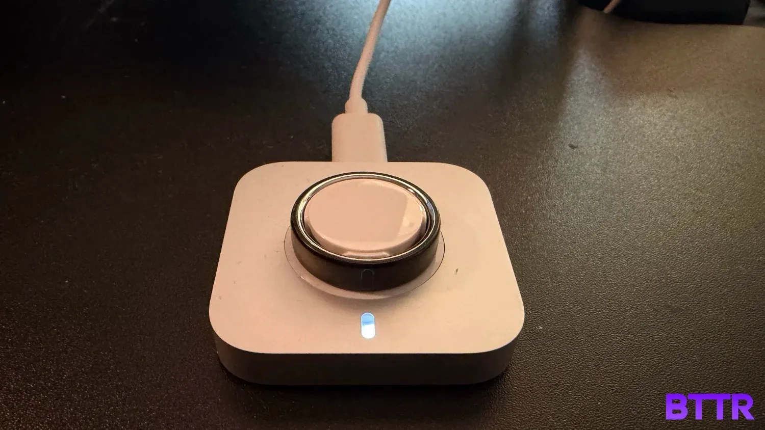 The Oura Ring 5 on its charger
