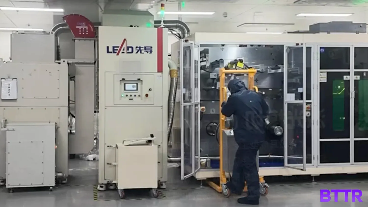 A worker in the factory in the room where the laser cutting happens