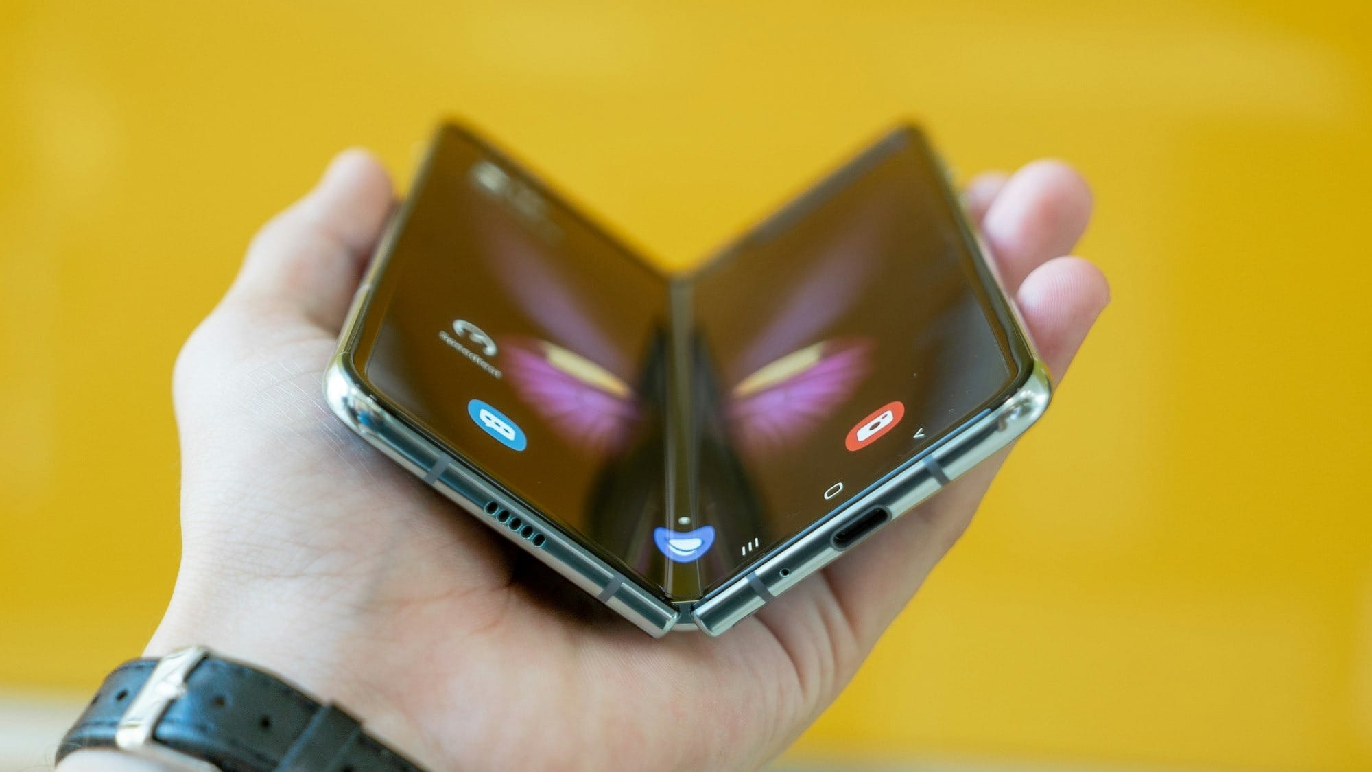 person holding black folding phone