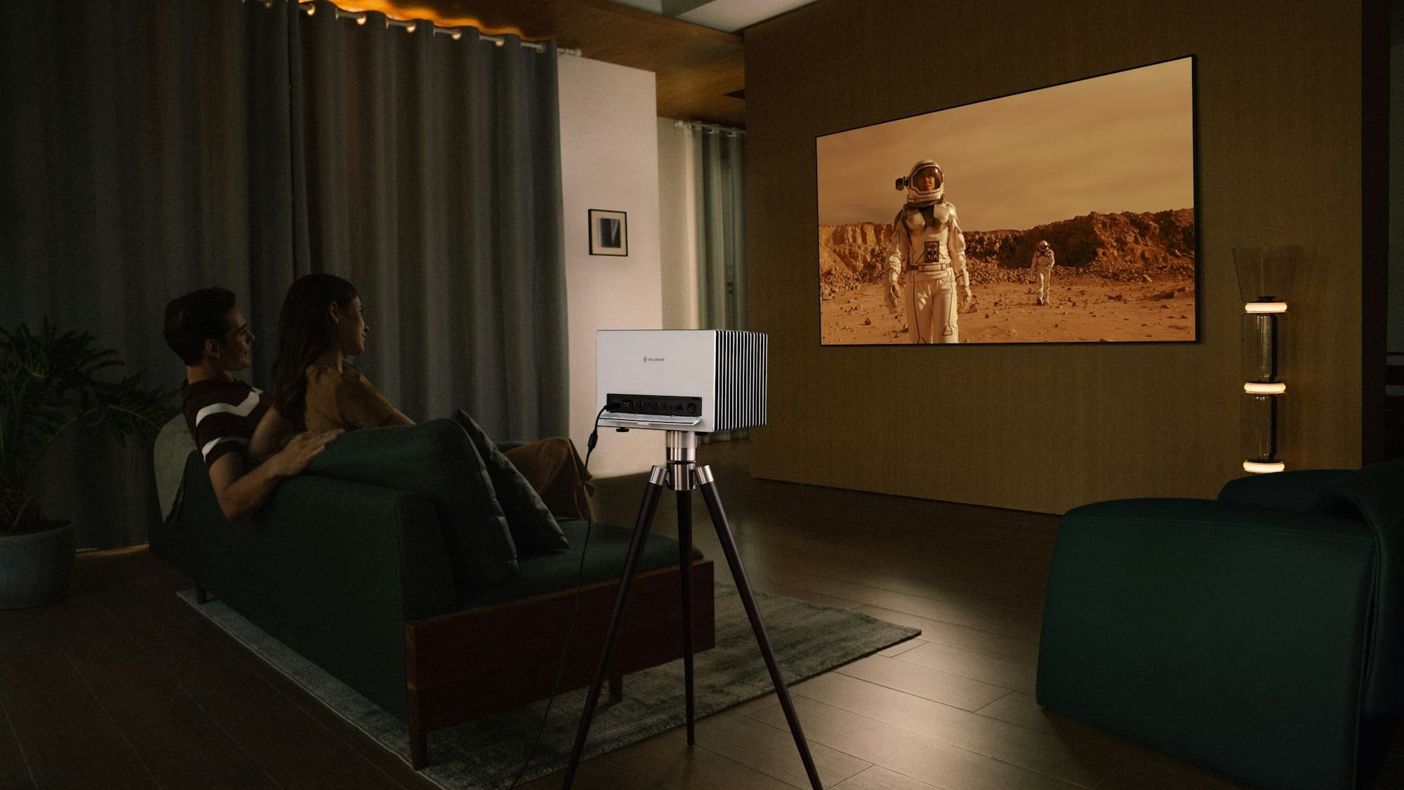 Couple watches movie projected onto wall