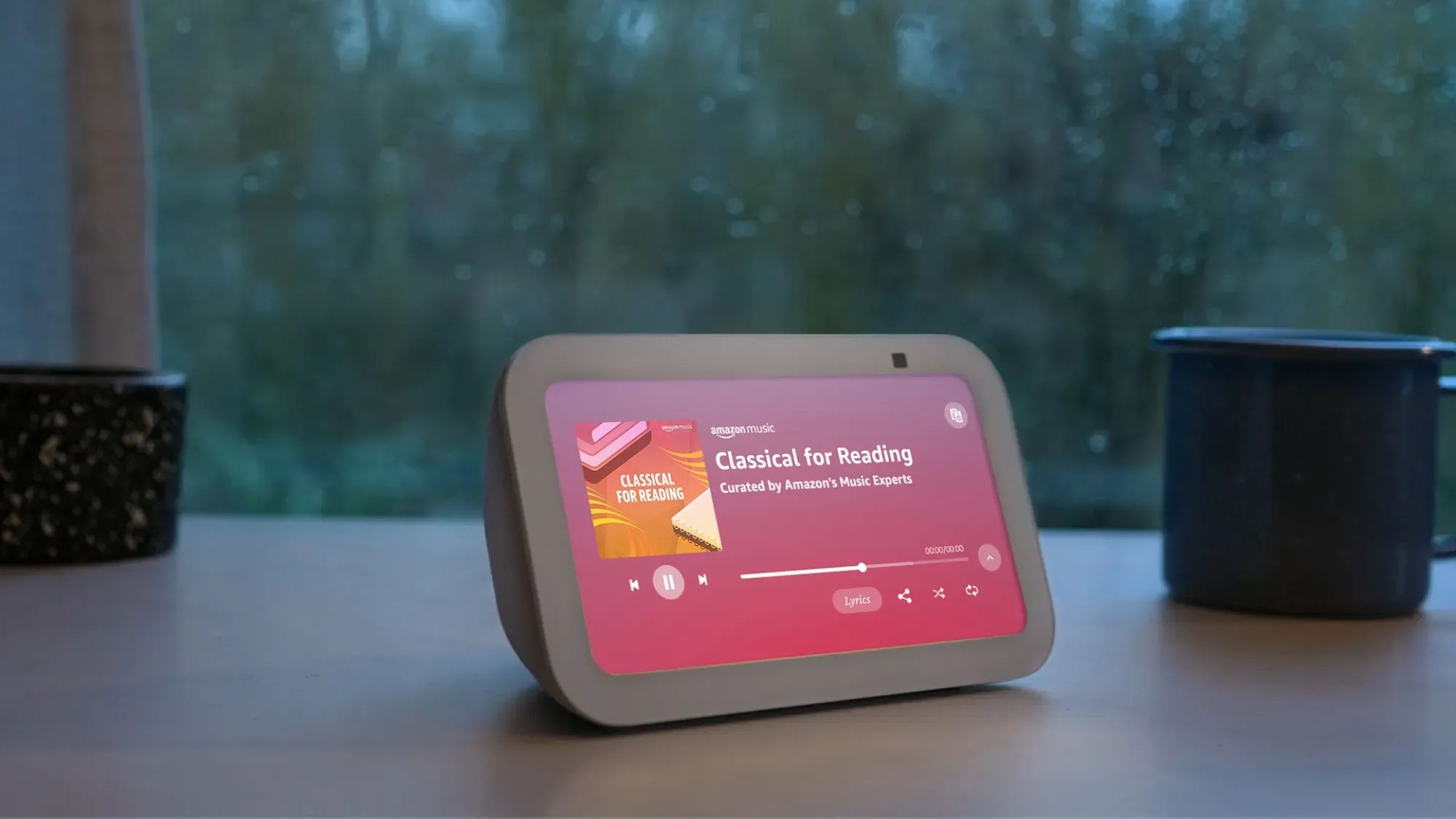 The Amazon Echo Show 5 on a desk playing music