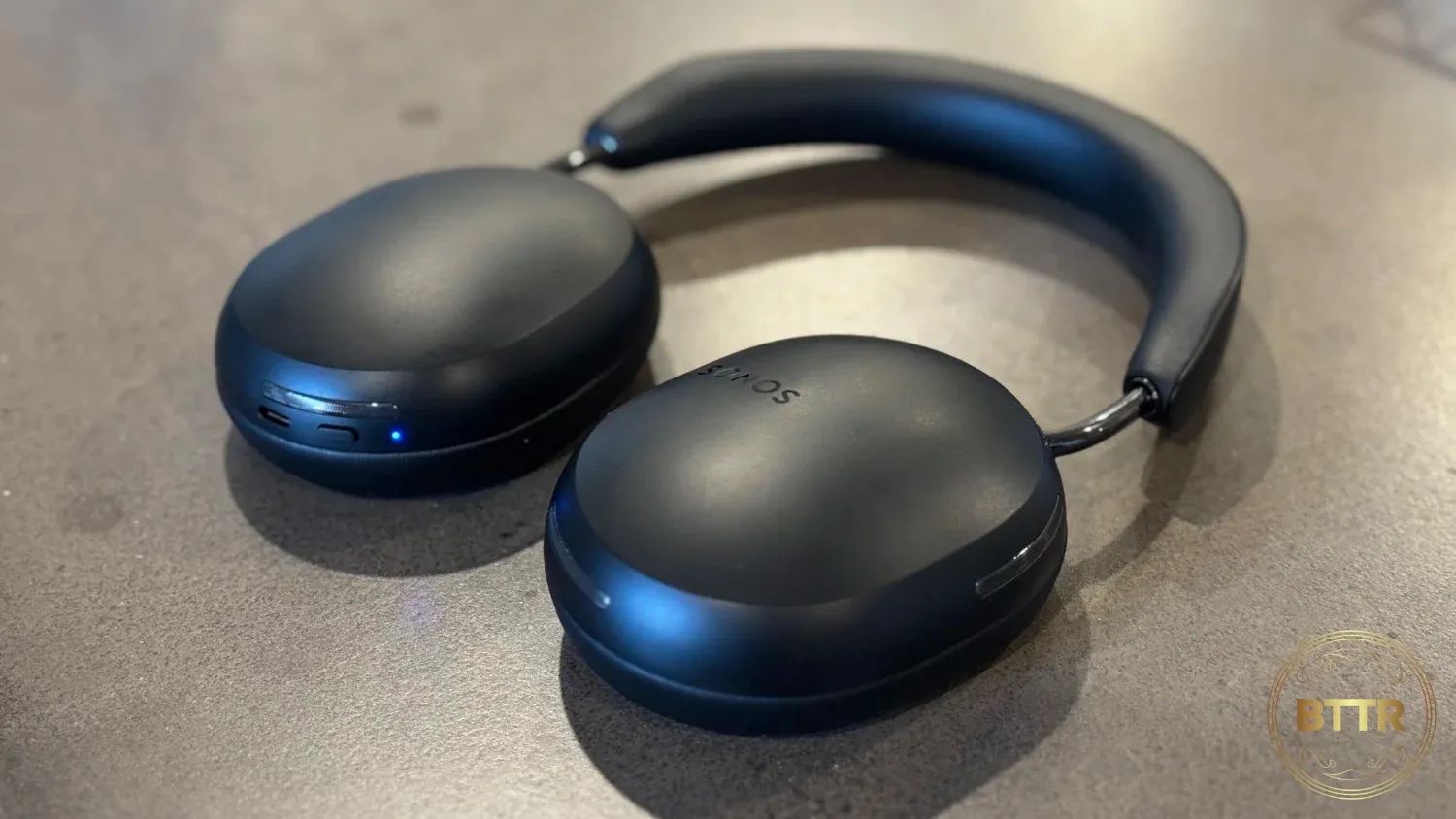 The Sonos Ace in black on a concrete table