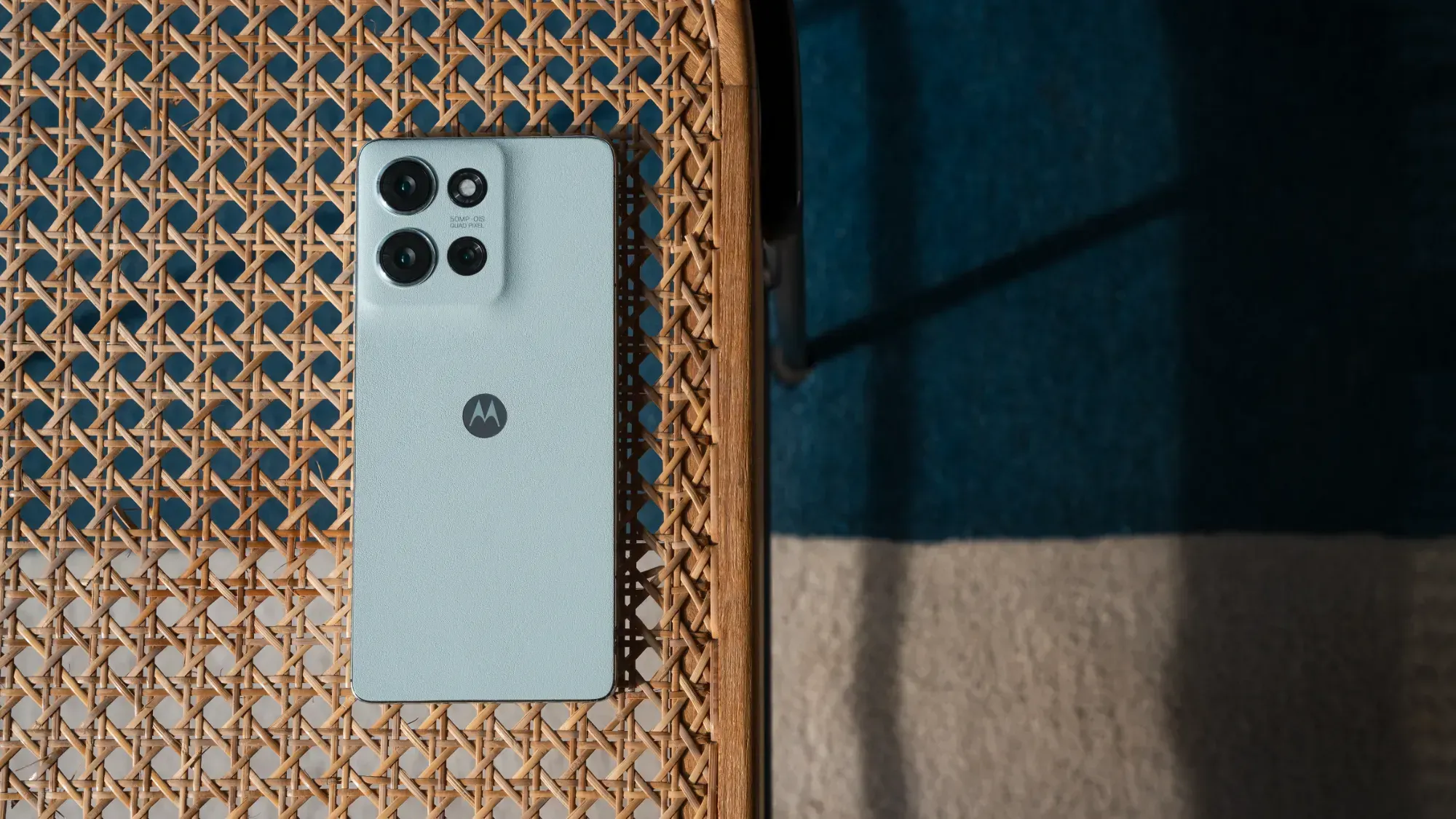 The Moto G75 5G on a cane chair