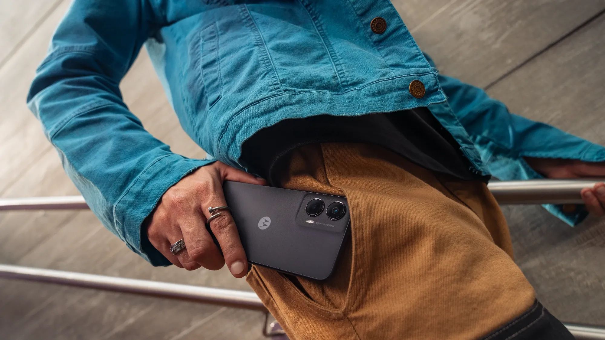 a man putting the moto g35 in his pocket