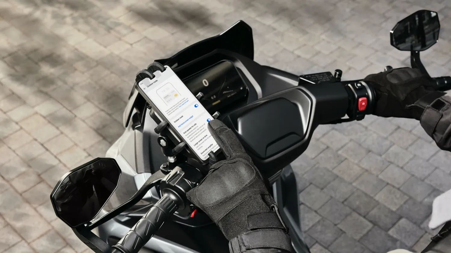 The OPPO A5 Pro 5G on a motorbike being controlled with thick gloves