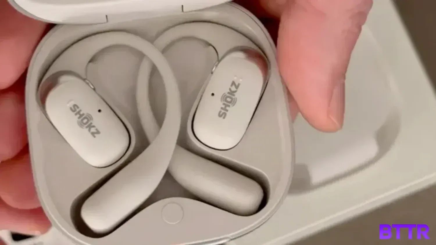 Holding the Shokz OpenFit2+ in the case