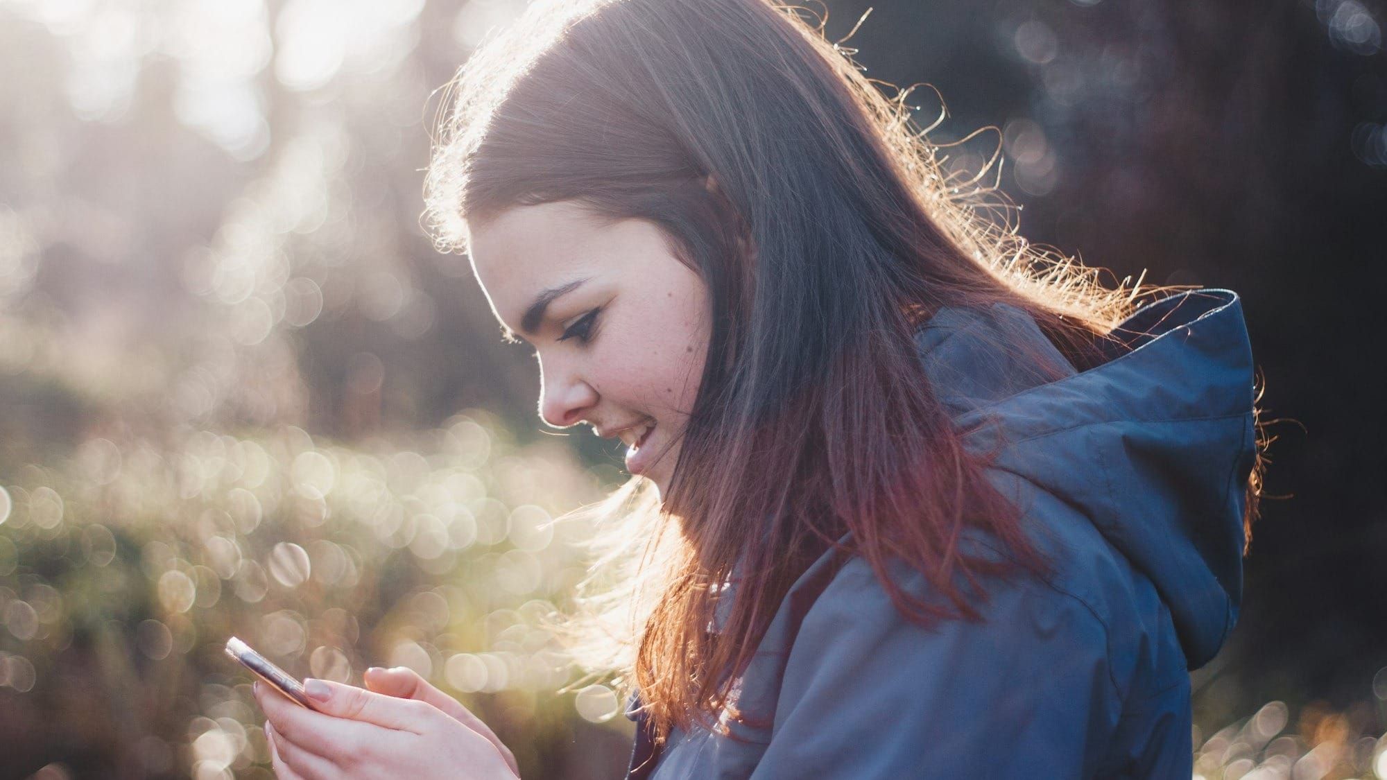 A teenage girl on her phone