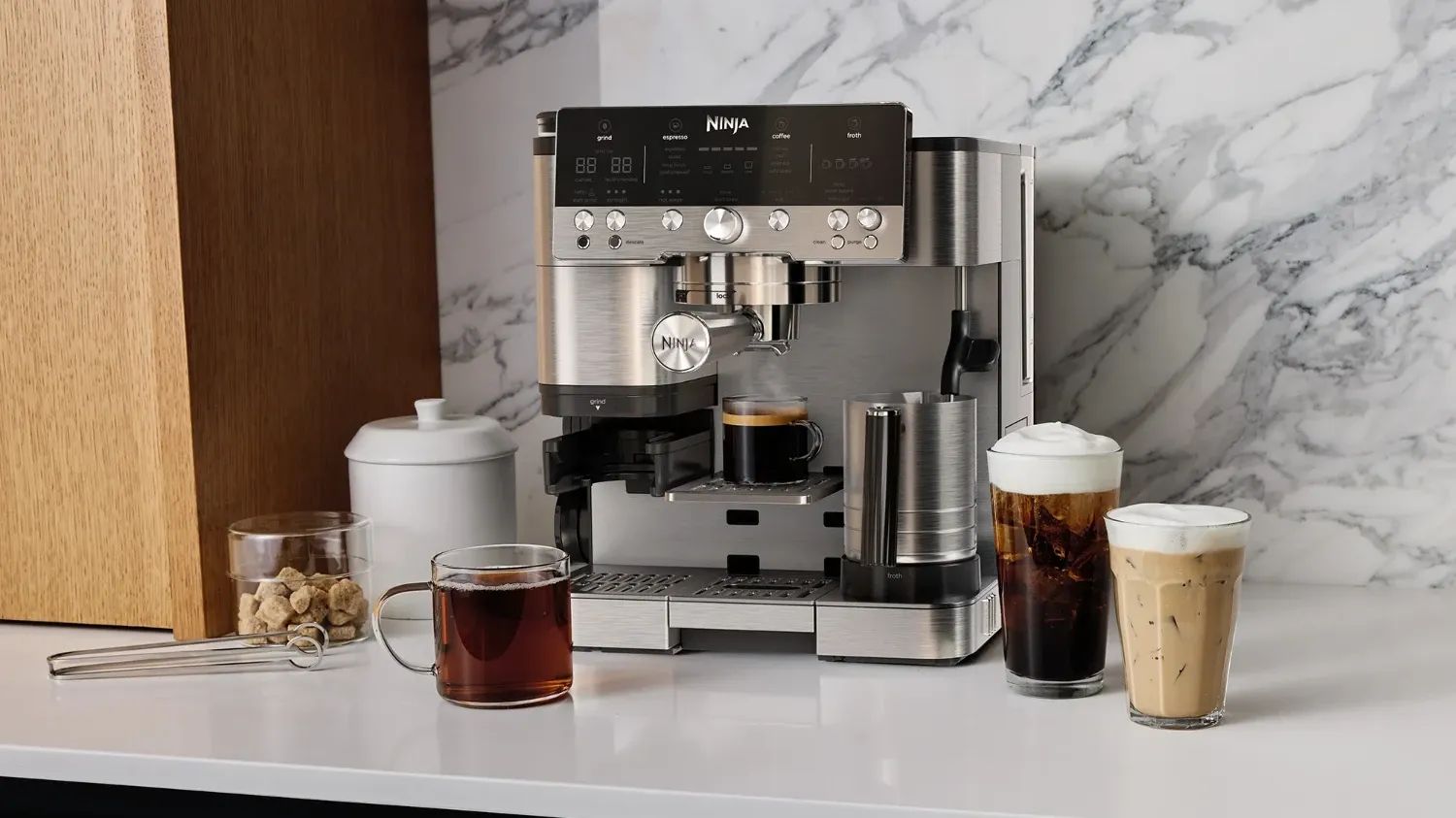 The Luxe Café on a benchtop with several coffees