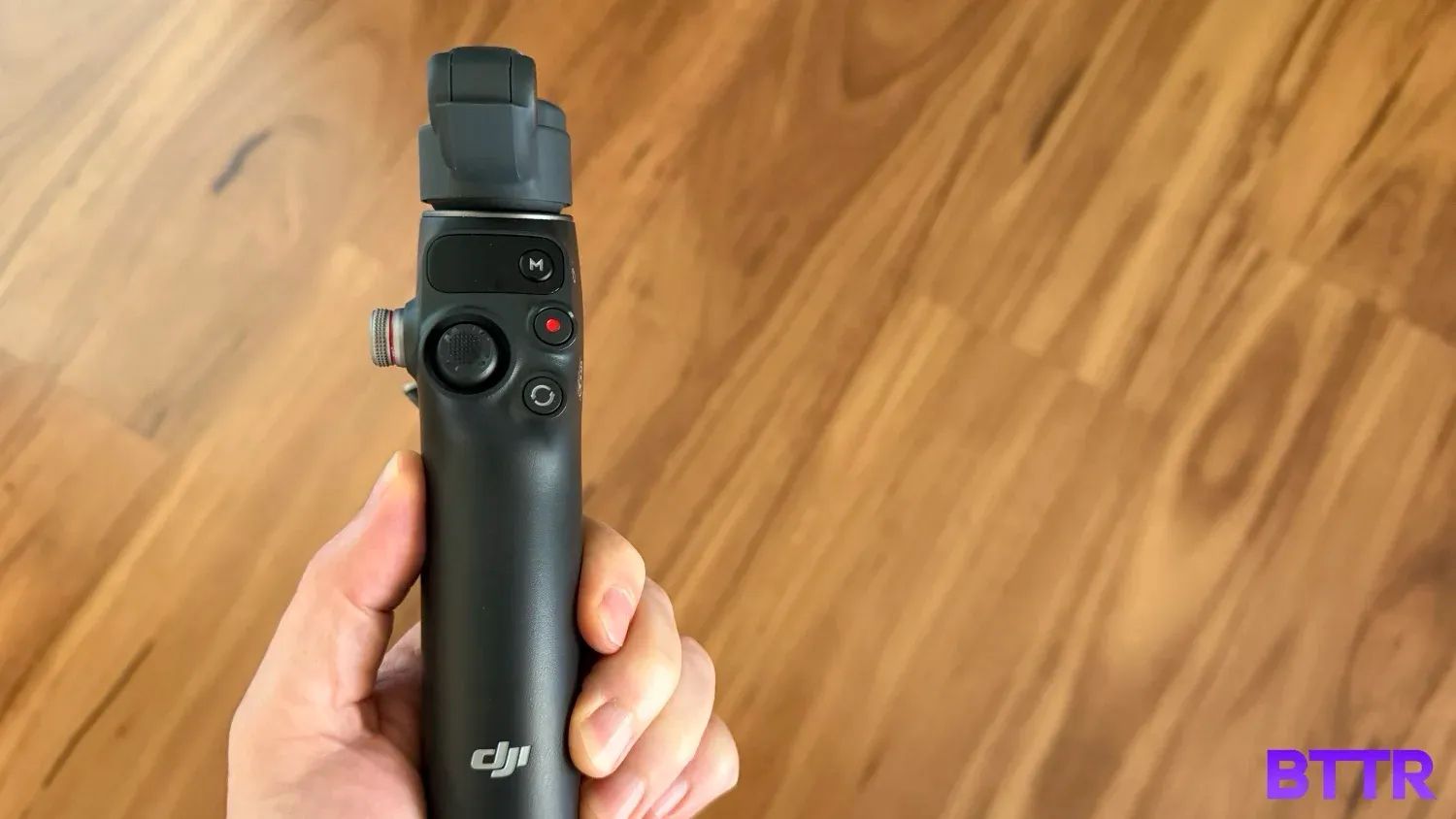 Holding the DJI Osmo Mobile 8 folded up in hand