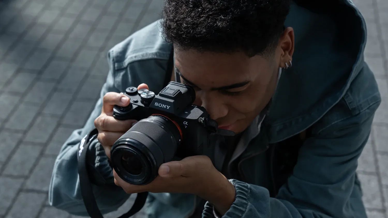 A man taking a photo with the Sony Alpha 7 V