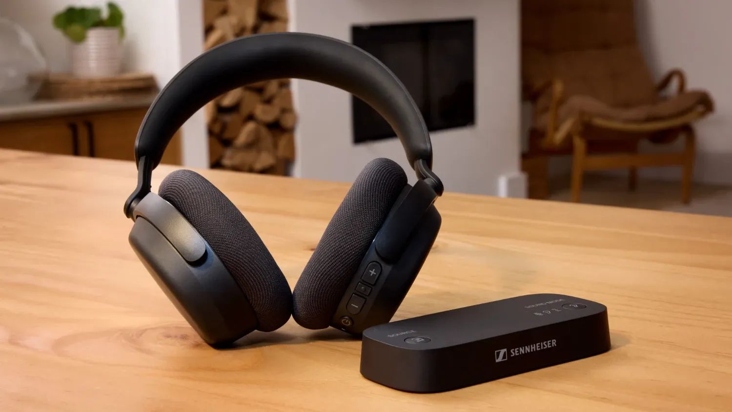 The Sennheiser RS 275 TV headphones and the Auracast transmitter on a wooden table