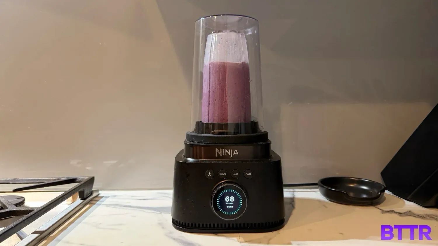 The Ninja Stealth IQ blender making a smoothie with the StealthShield lid
