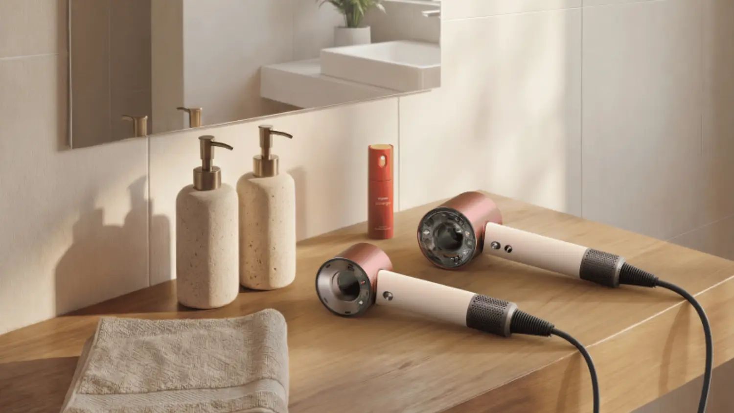 The Dyson Supersonic Travel on a bathroom bench next to the full sized model