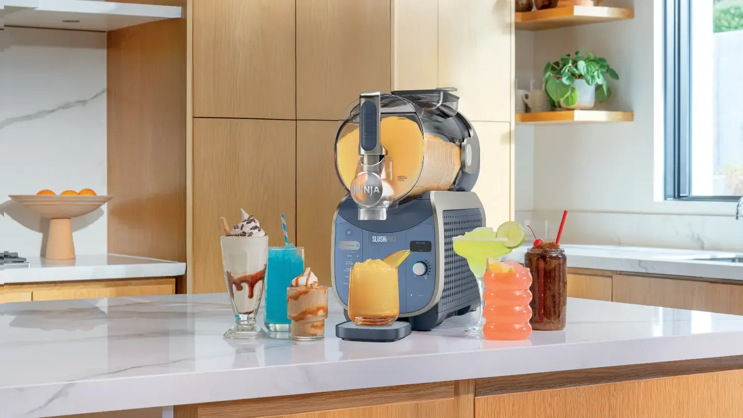 The Ninja Slushi Max on a countertop surrounded by drinks.