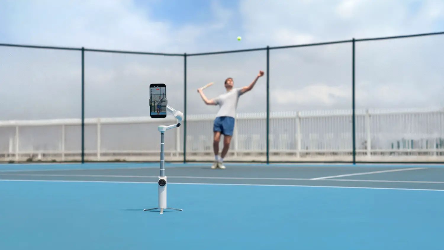 A man using an insta360 gimbal to track him playing tennis, 