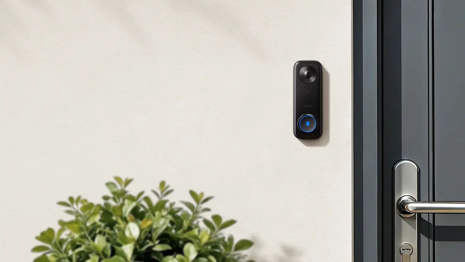 The Aqara G400 wired video doorbell next to a grey door.