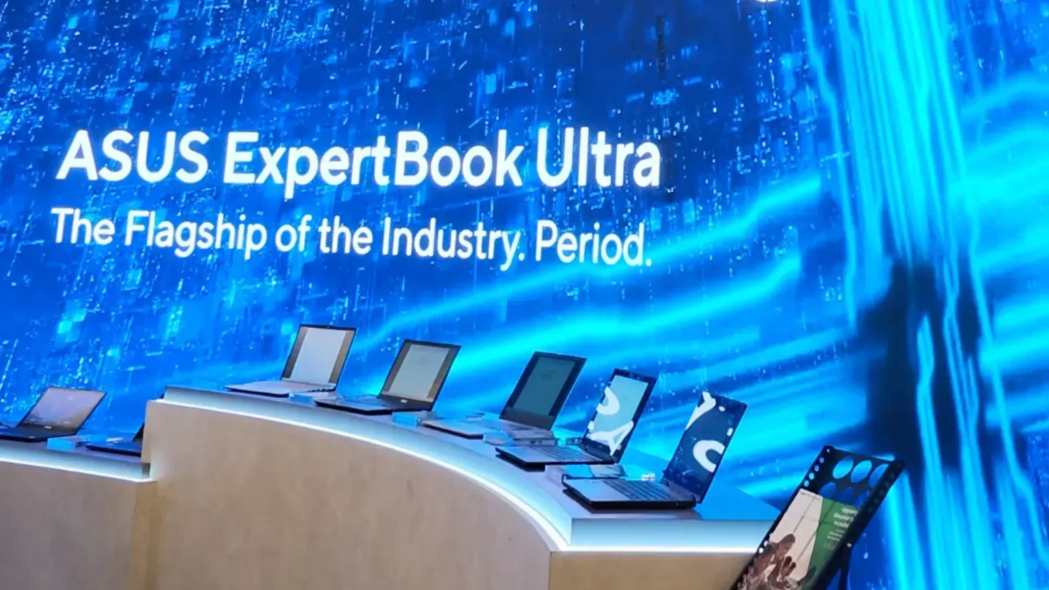 An image of a lineup of laptops in front of a screen saying ASUS Expertbook Ultra. The Flagship of the Industry. Period.