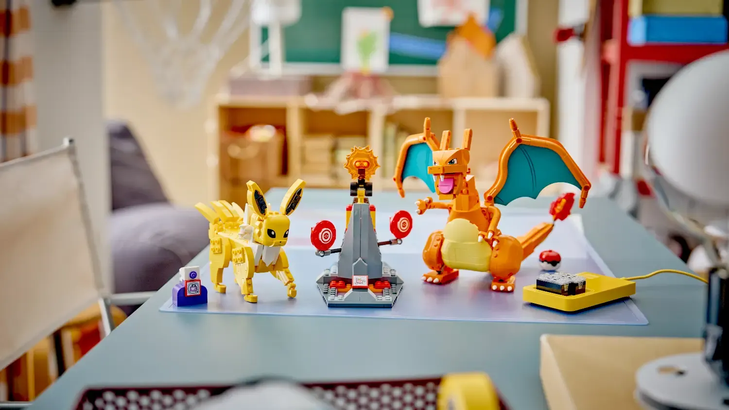 Lego Pokémon smart bricks in action ona. table with the Charizard vs Bolteon Battle set.