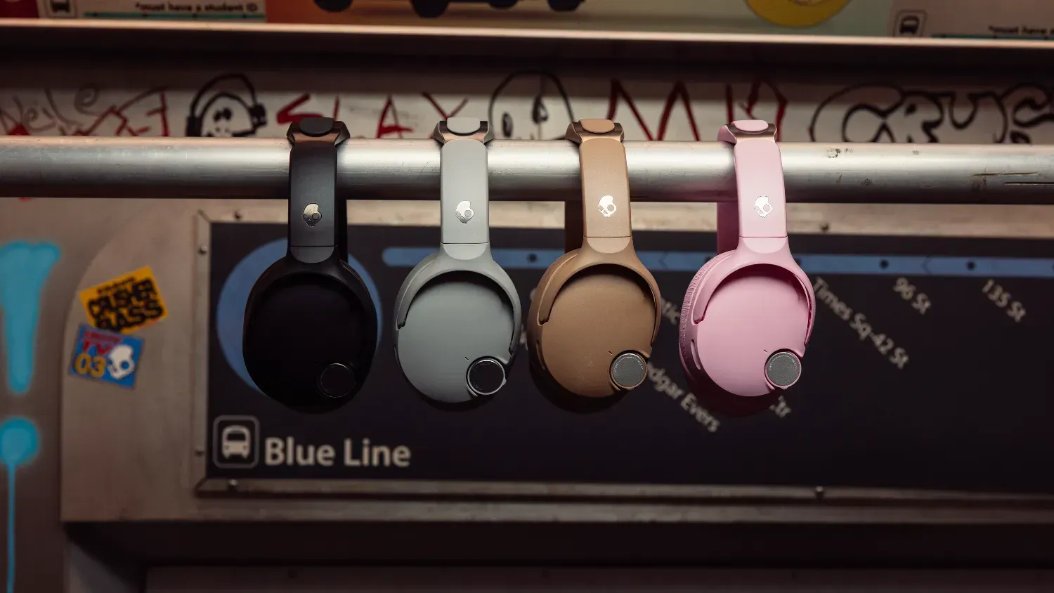 The four colour sof SkullCandy Crusher 1080 ANC hanging on a rail in a train