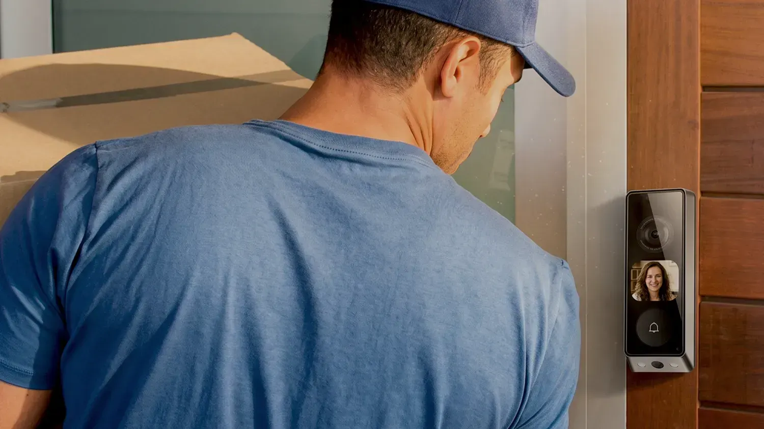A delivery man talking to a woman through the new EZVIZ doorbell